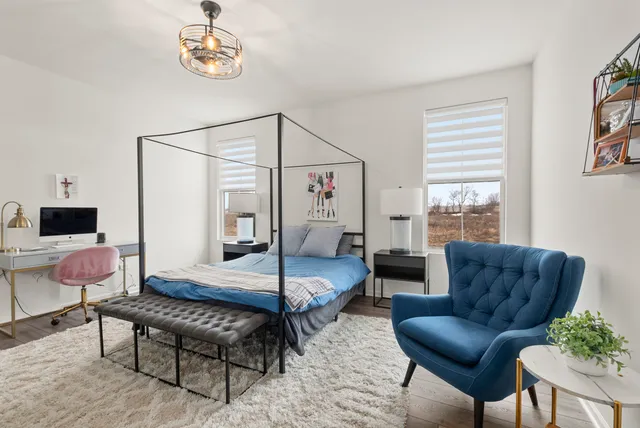 a bedroom with furniture and a window