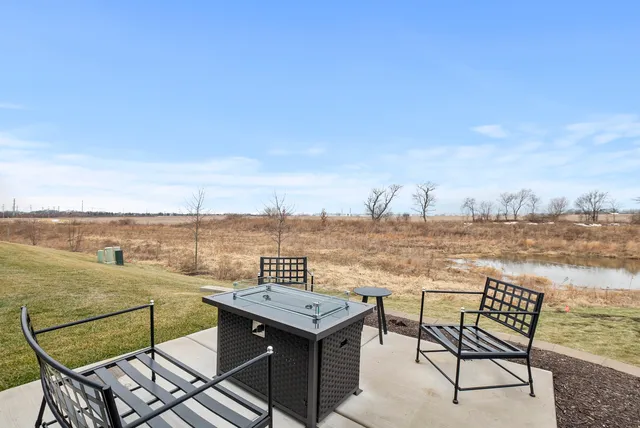 a view of a terrace with a table and chairs