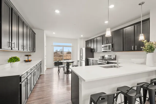 a kitchen with sink a refrigerator and cabinets