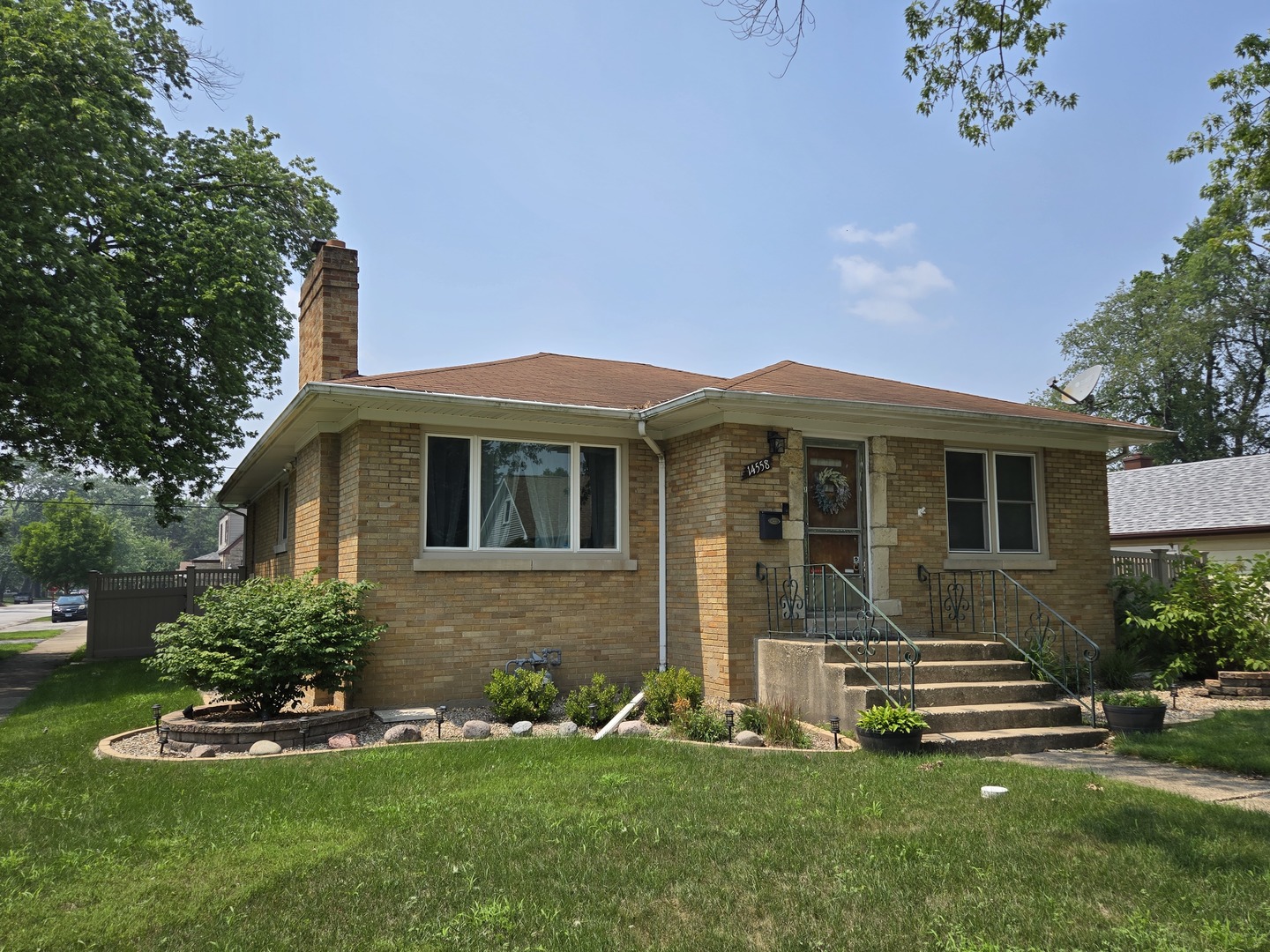 14558 Turner Avenue Midlothian, IL 60445 - Photo 1 of 20 a front view of a house with a garden and yard