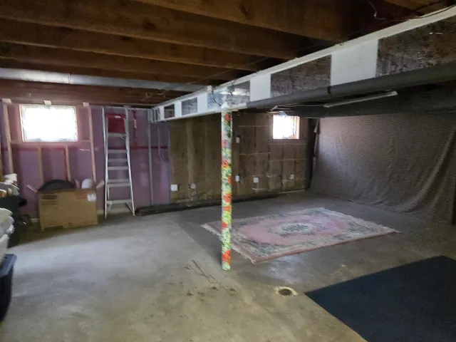 a room with water heater and a washer dryer