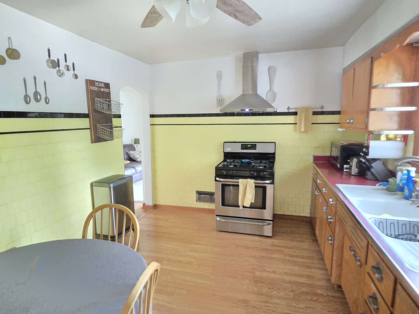 14558 Turner Avenue Midlothian, IL 60445 - Photo 6 of 20 a kitchen with stainless steel appliances wooden floor and a stove top oven