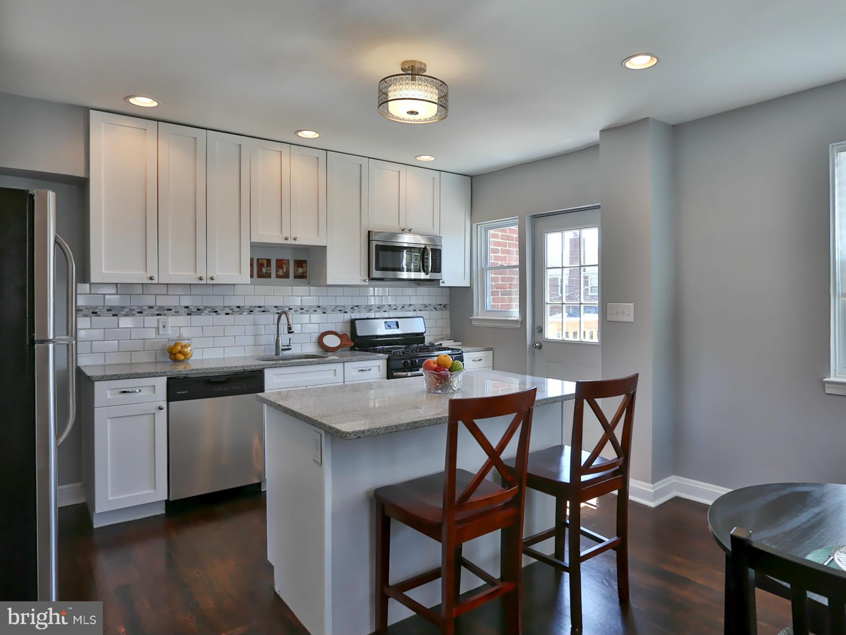 1201 Gleneagle Road Baltimore, MD 21239 - Photo 9 of 30 Kitchen With Island & Breakfast Bar