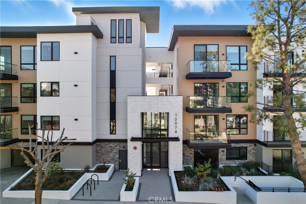 12078 Guerin Street, Unit 103 Studio City, CA 91604 - Photo 7 of 7 a front view of a building with a garden