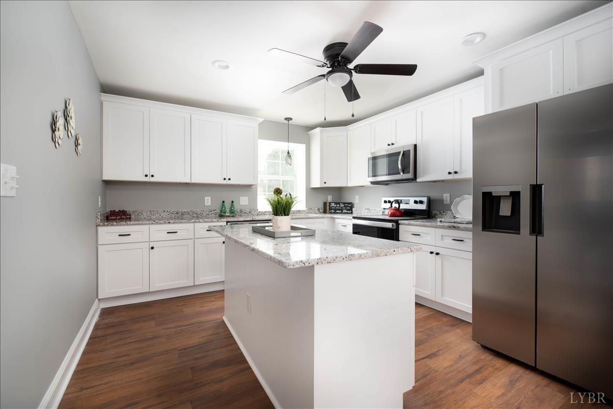 132 Spring Street Madison Heights, VA 24572 - Photo 11 of 63 a kitchen with white cabinets and stainless steel appliances