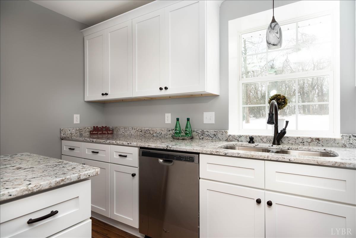 132 Spring Street Madison Heights, VA 24572 - Photo 16 of 63 a kitchen with granite countertop white cabinets and white appliances