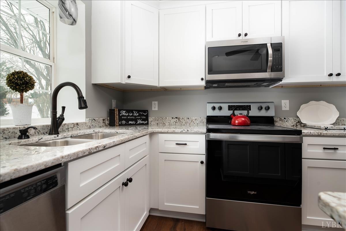 132 Spring Street Madison Heights, VA 24572 - Photo 18 of 63 a kitchen with stainless steel appliances granite countertop a sink and a stove