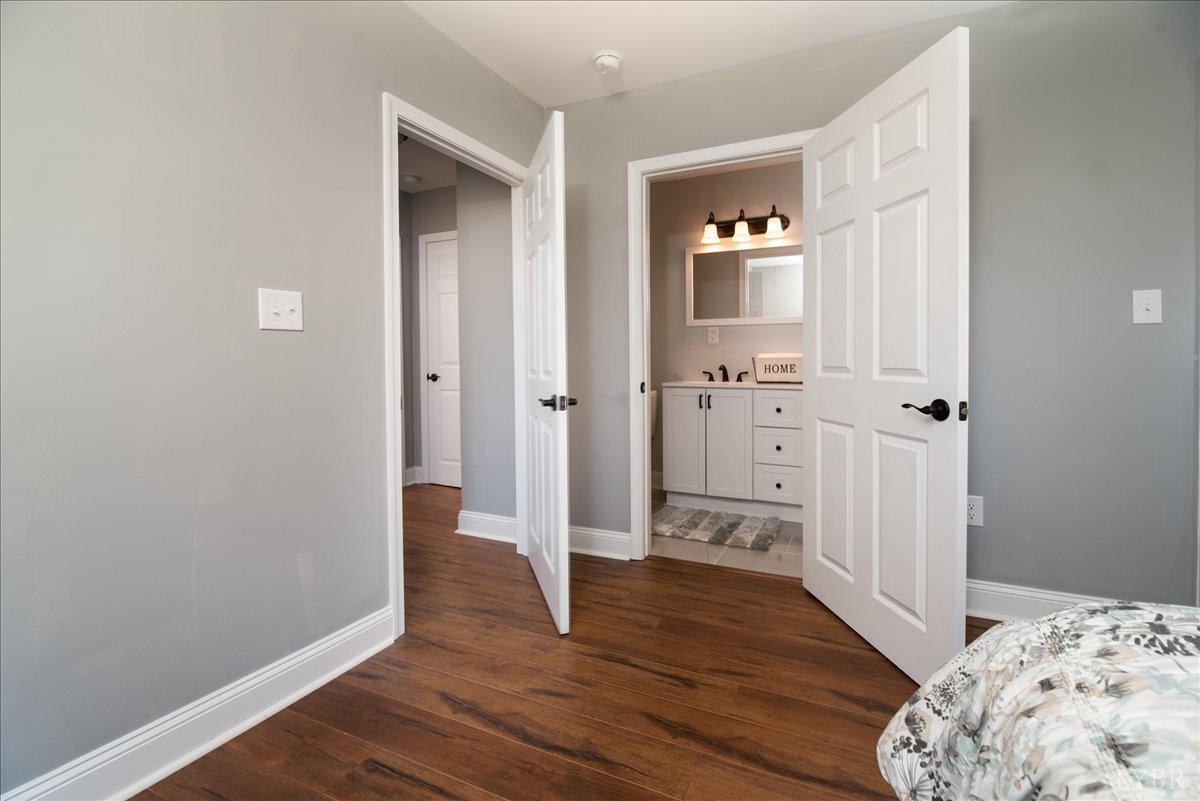 132 Spring Street Madison Heights, VA 24572 - Photo 24 of 63 a view of a hallway with wooden floor and a bathroom