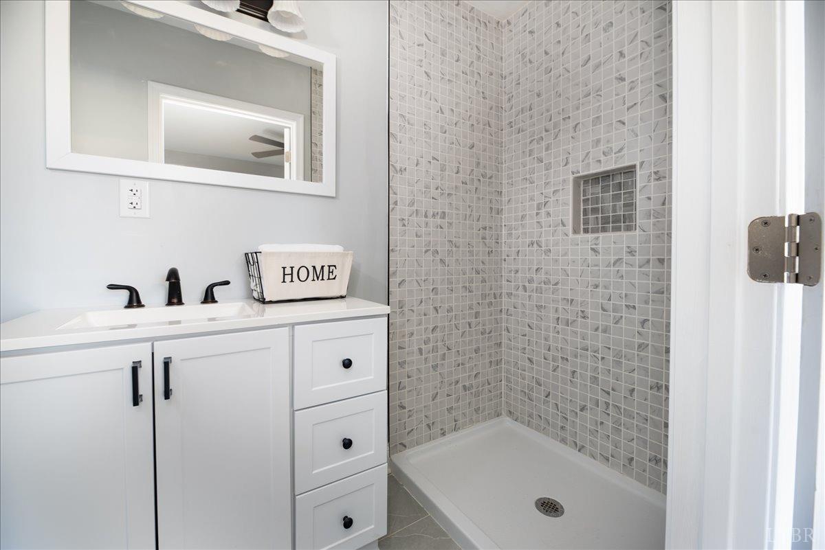 132 Spring Street Madison Heights, VA 24572 - Photo 26 of 63 a bathroom with a shower sink and mirror