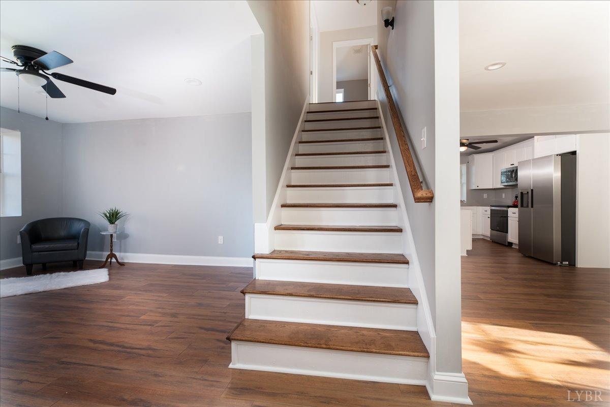 132 Spring Street Madison Heights, VA 24572 - Photo 28 of 63 a view of an empty room with wooden floor and stairs