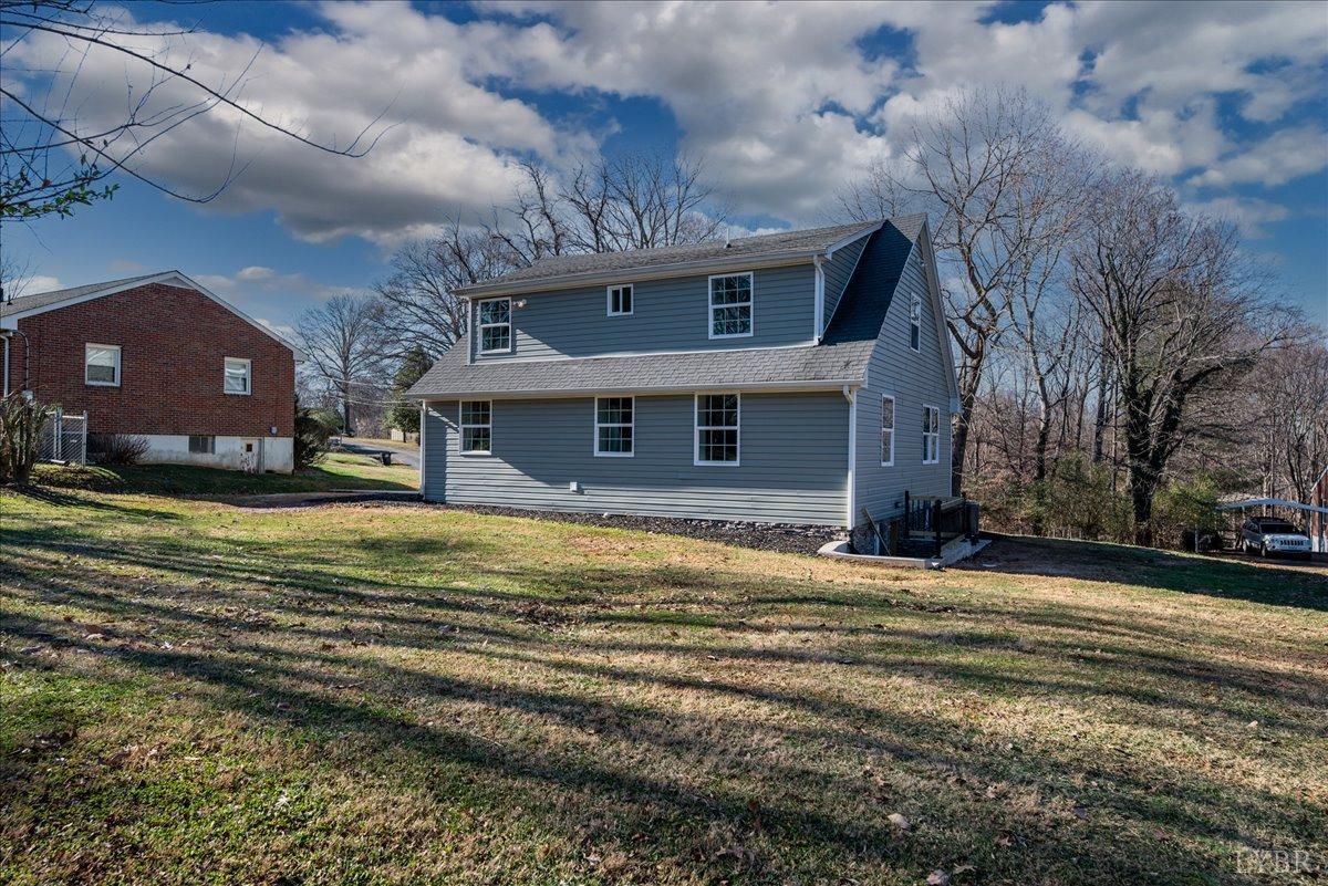 132 Spring Street Madison Heights, VA 24572 - Photo 50 of 63 a view of a house next to a big yard with large tree