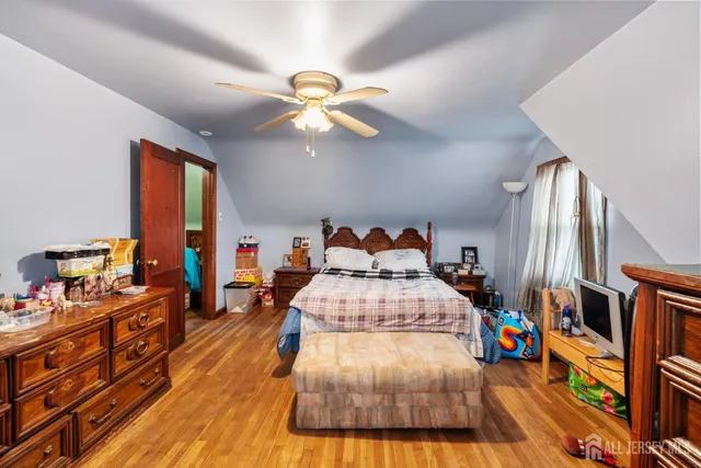 a bedroom with furniture and a wooden floor