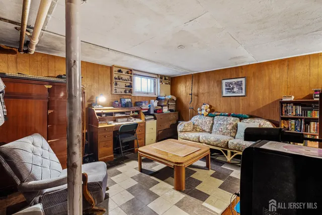 a living room with furniture a rug and a window