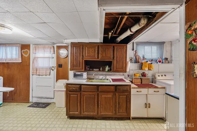 a kitchen with a sink cabinets and window