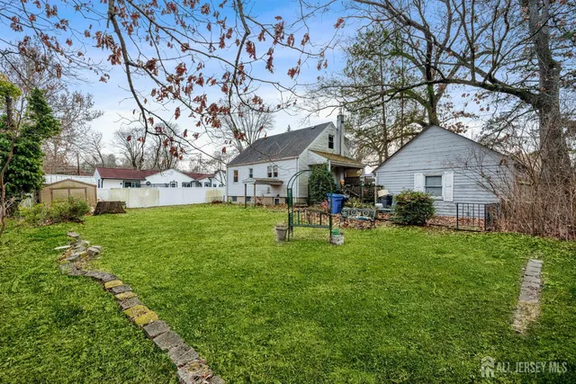 a backyard of a house with table and chairs