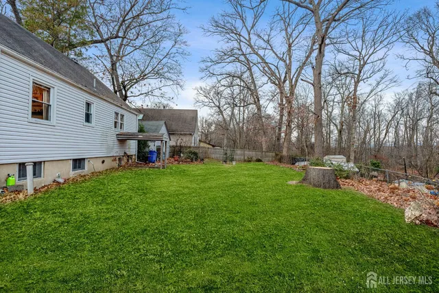 a view of a house with backyard sitting area and garden