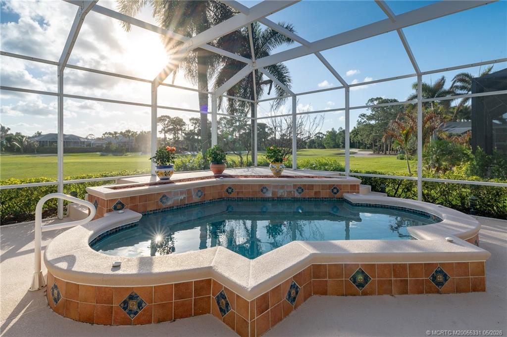 2216 Southeast Stonehaven Road Port St. Lucie, FL 34952 - Photo 26 of 67 a view of a swimming pool with a lounge chairs