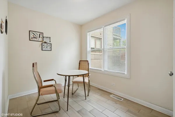 a view of a room that has a window and chair