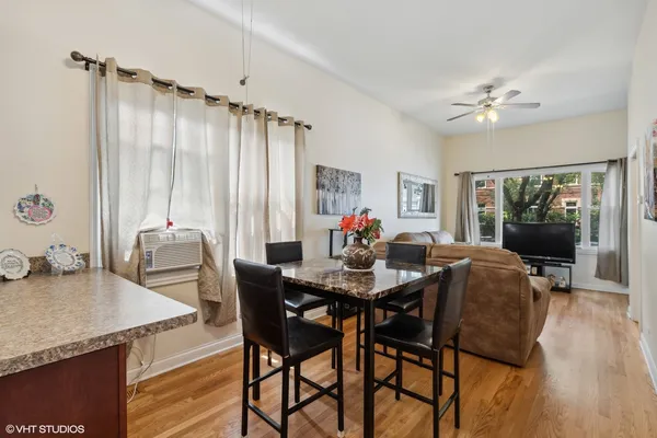 a view of a dining room with furniture window and wooden floor