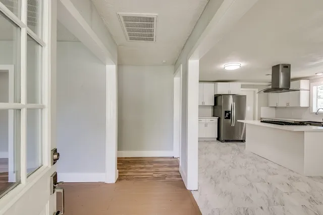 a kitchen with refrigerator and cabinets