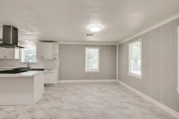 a kitchen with granite countertop a stove sink and microwave