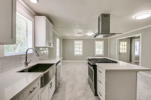 a kitchen with a sink stove and cabinets