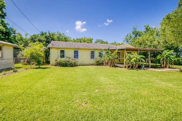 a front view of house with yard and green space