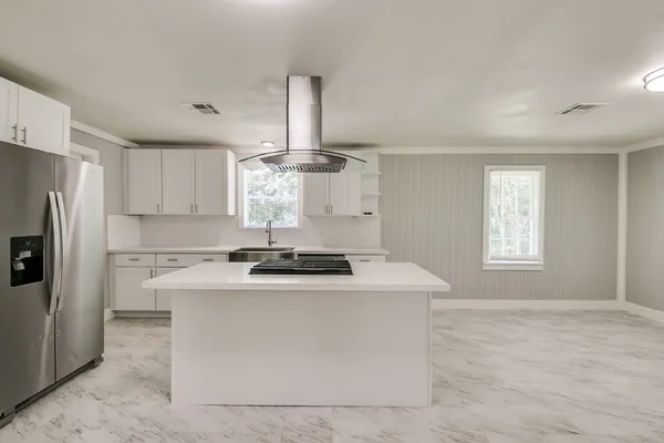 a kitchen with a stove a sink and a refrigerator