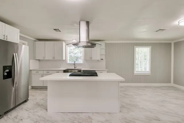a kitchen with a stove a sink and a refrigerator