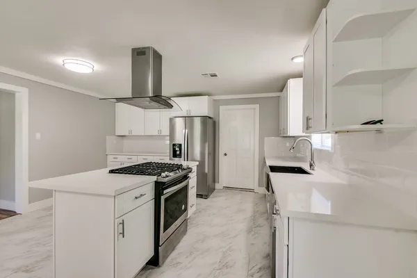 a kitchen with a stove and a refrigerator