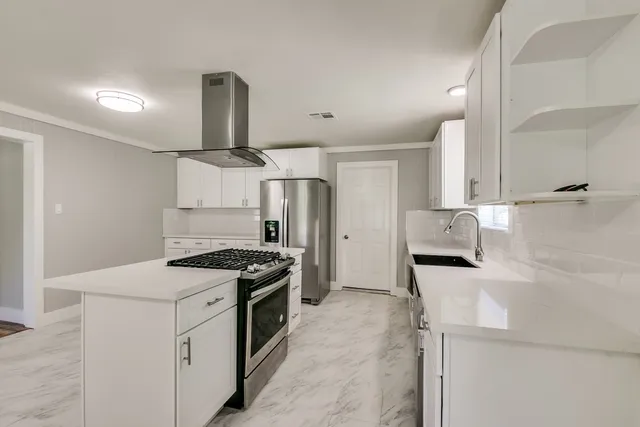 a kitchen with a stove and a refrigerator