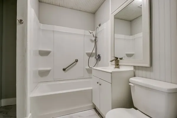 a bathroom with a toilet sink and shower