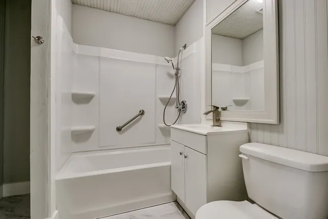 a bathroom with a toilet sink and shower