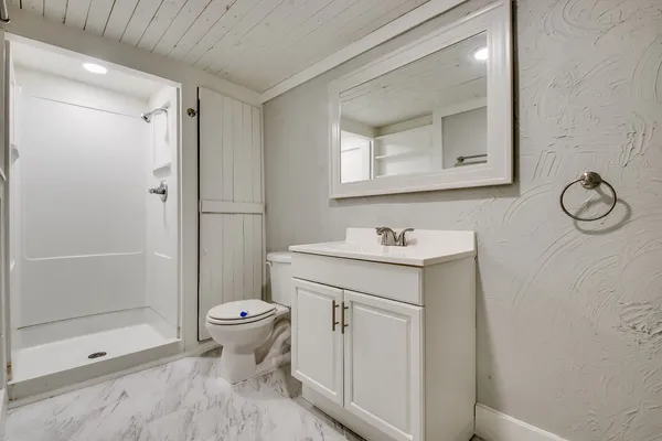 a bathroom with a sink toilet and shower