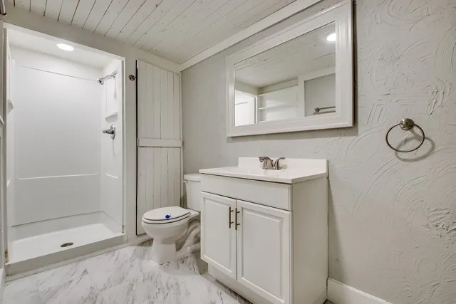 a bathroom with a sink toilet and shower
