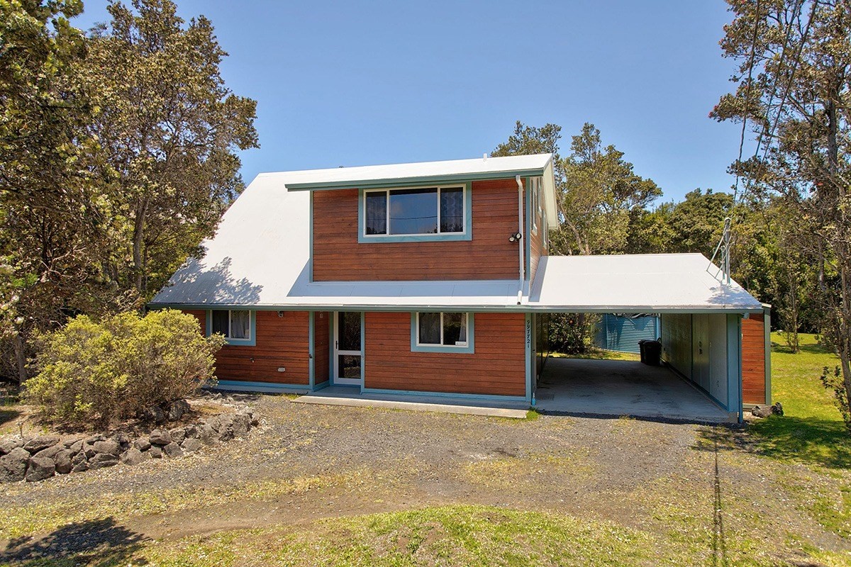 a house that has a tree in front of it
