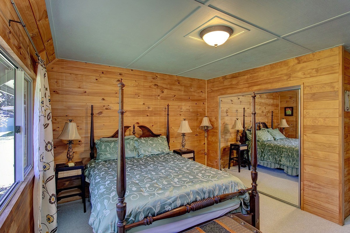 99-7721 Kilau Place Volcano, HI 96785 - Photo 12 of 26 a bedroom with a bed and a mirror