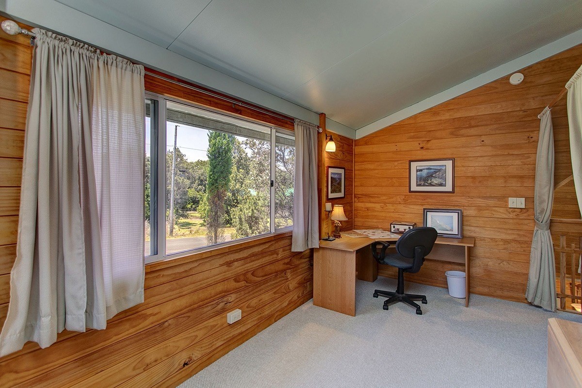 99-7721 Kilau Place Volcano, HI 96785 - Photo 14 of 26 a view of a workspace with furniture and a window
