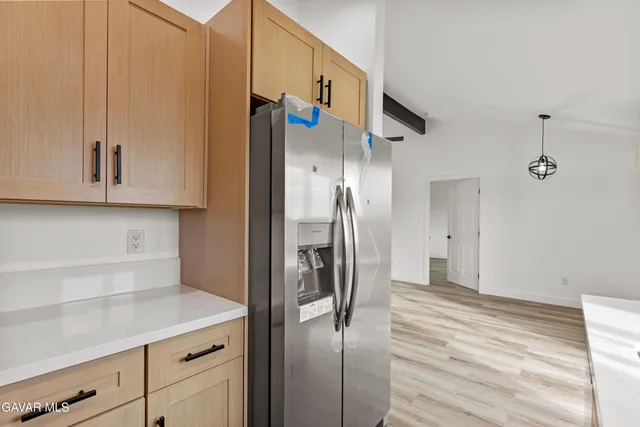 a kitchen with stainless steel appliances granite countertop a refrigerator and a sink