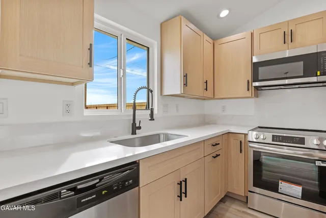 a kitchen with a sink stove and microwave