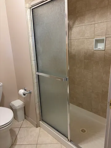 a bathroom with a toilet and a shower