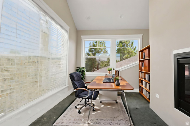 580 North 300 East Logan, UT 84321 - Photo 51 of 74 Bright interior space featuring multiple windows, sloped ceiling, recessed lighting, and a built-in fireplace with a black surround