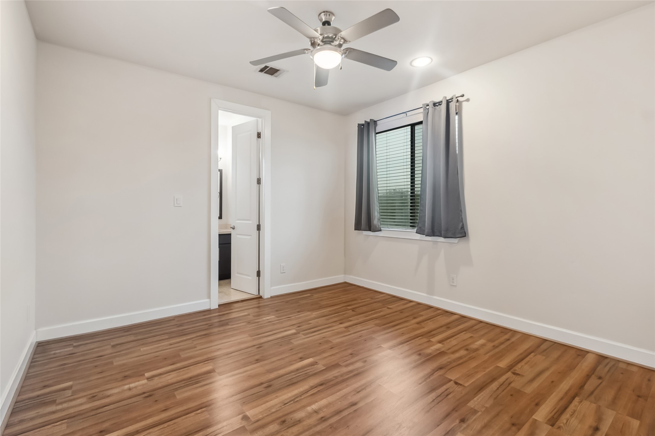 5729 Larkin Street, Unit A Houston, TX 77007 - Photo 15 of 23 an empty room with wooden floor a ceiling fan and closet