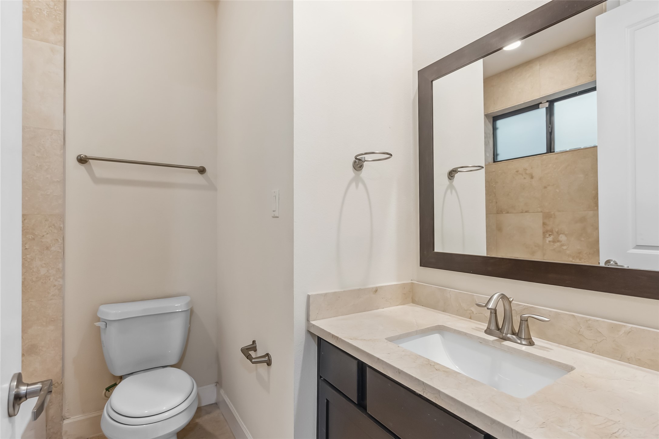 5729 Larkin Street, Unit A Houston, TX 77007 - Photo 18 of 23 a bathroom with a granite countertop toilet sink and mirror