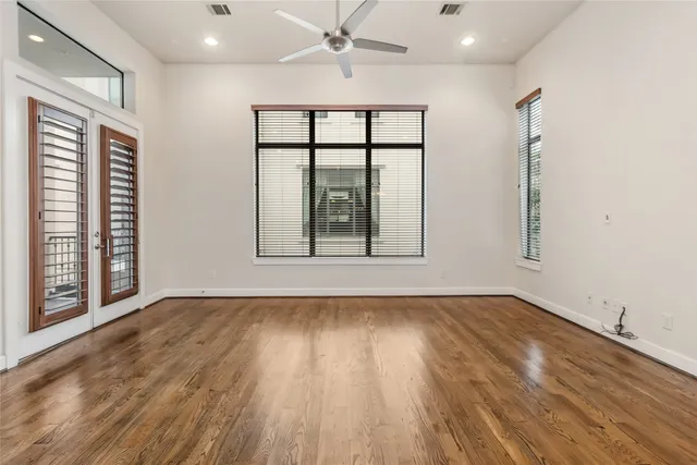 wooden floor in an empty room with a window