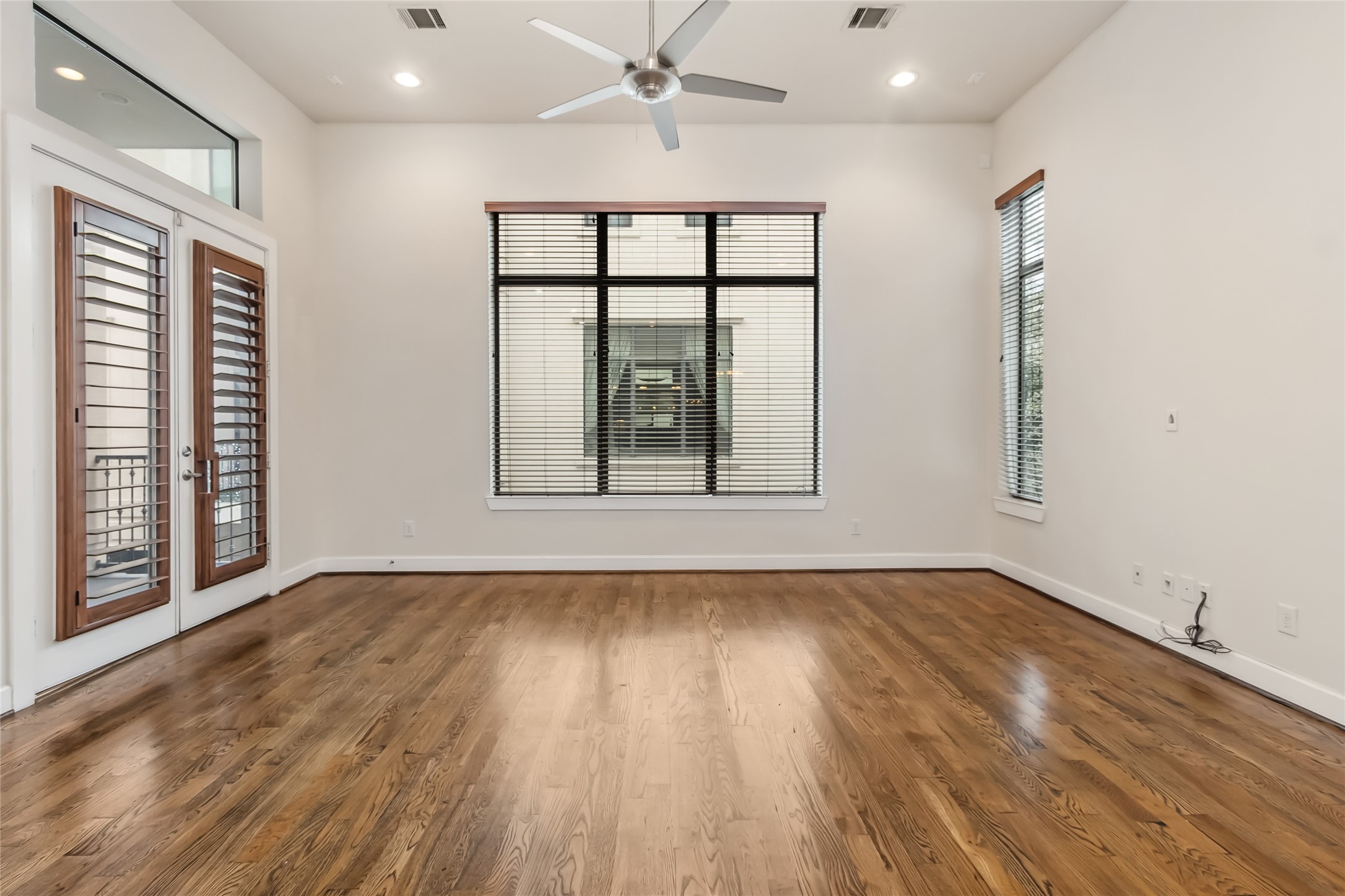 5729 Larkin Street, Unit A Houston, TX 77007 - Photo 3 of 23 wooden floor in an empty room with a window