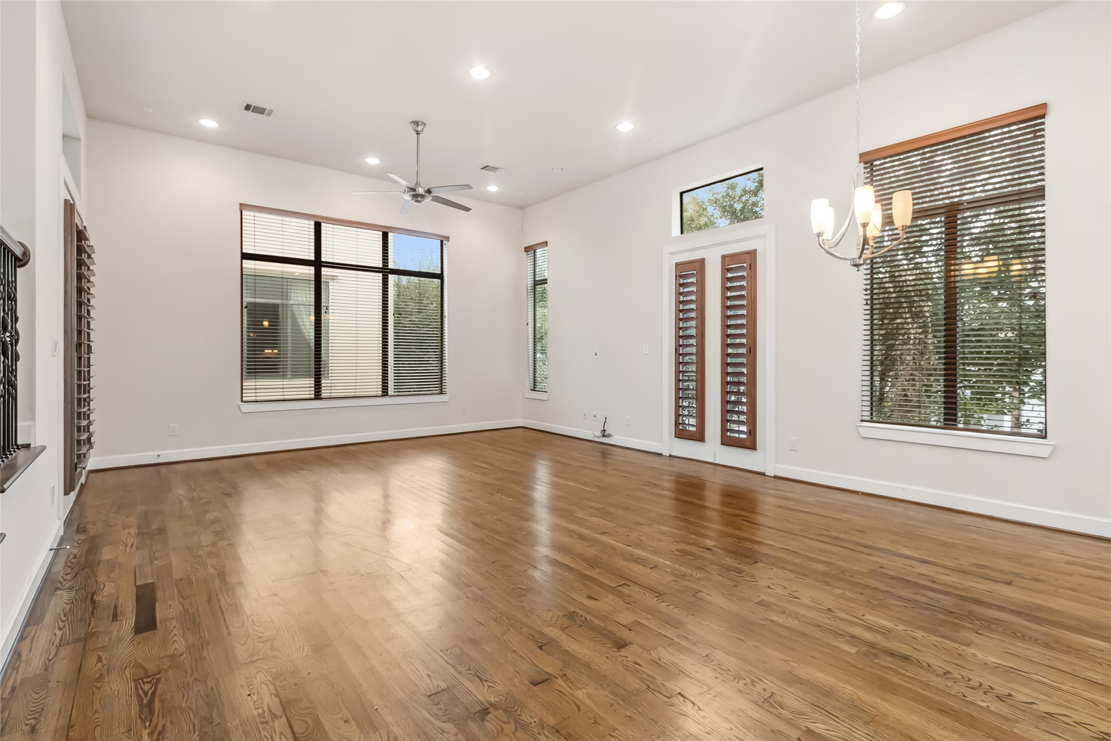 5729 Larkin Street, Unit A Houston, TX 77007 - Photo 4 of 23 a view of an empty room with wooden floor and a window