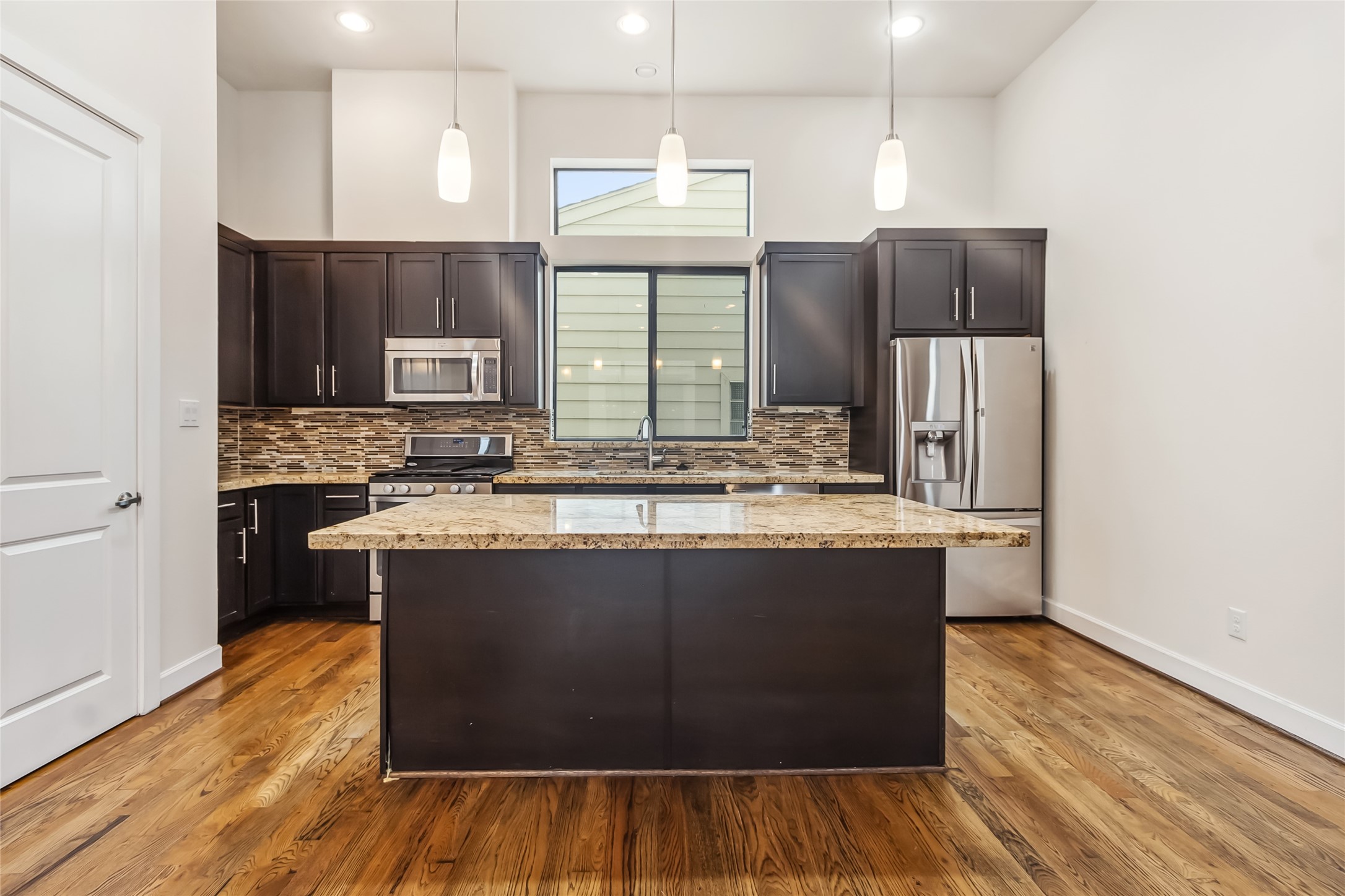 5729 Larkin Street, Unit A Houston, TX 77007 - Photo 6 of 23 a kitchen with stainless steel appliances granite countertop a stove and a refrigerator