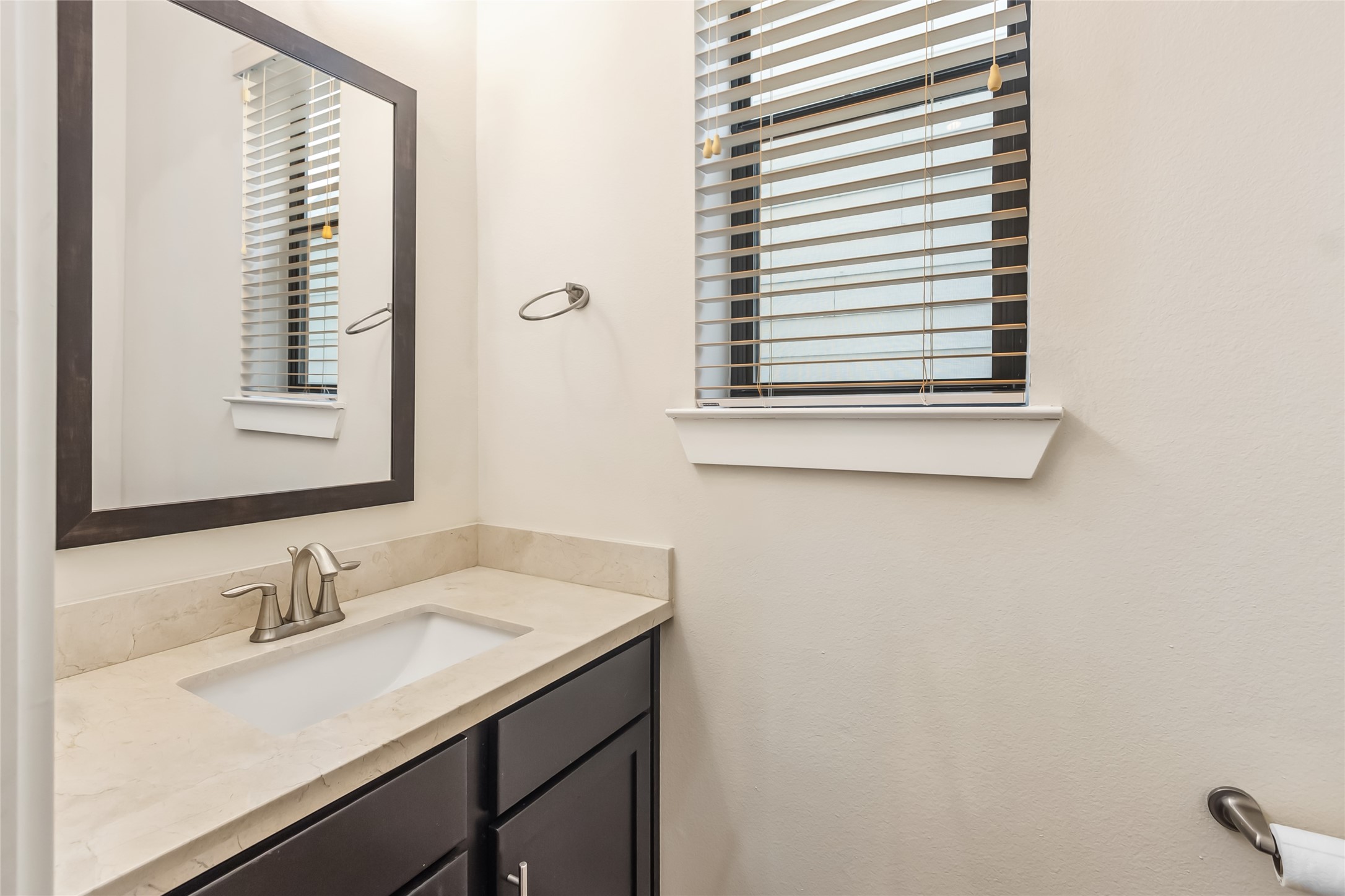 5729 Larkin Street, Unit A Houston, TX 77007 - Photo 9 of 23 a bathroom with a granite countertop sink and a window