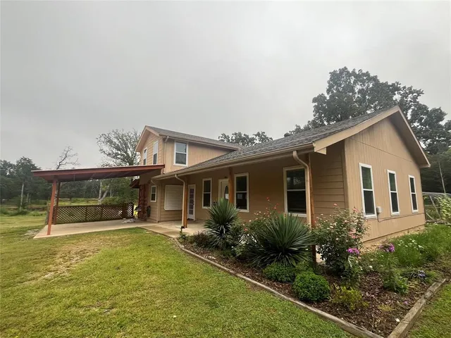 a view of a house with backyard porch and sitting area
